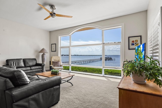 living room featuring ceiling fan, carpet floors, and plenty of natural light