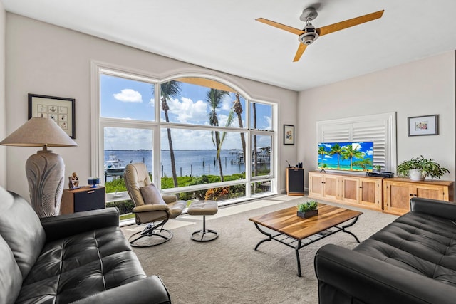 carpeted living room with ceiling fan and plenty of natural light