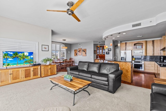 living room with light carpet and ceiling fan