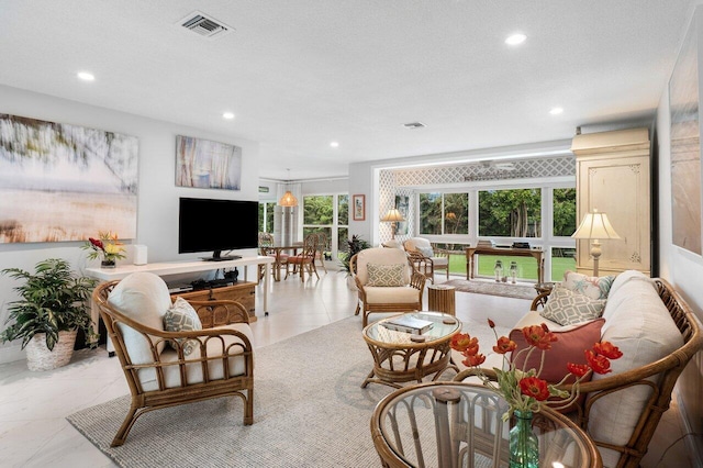 living area featuring visible vents and recessed lighting