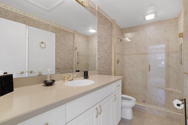 bathroom with vanity, a shower with shower door, toilet, and tile patterned flooring