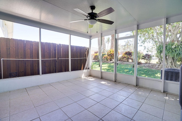 unfurnished sunroom featuring a healthy amount of sunlight and ceiling fan