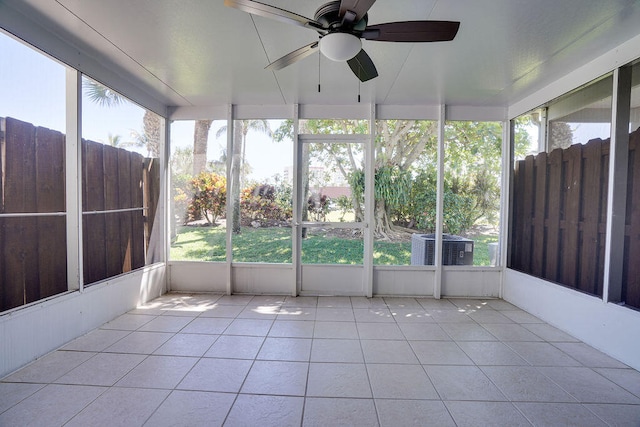 unfurnished sunroom featuring ceiling fan