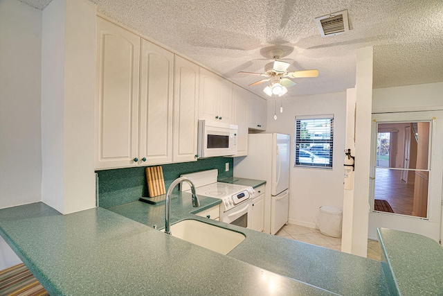 kitchen with ceiling fan, sink, white appliances, a textured ceiling, and white cabinetry