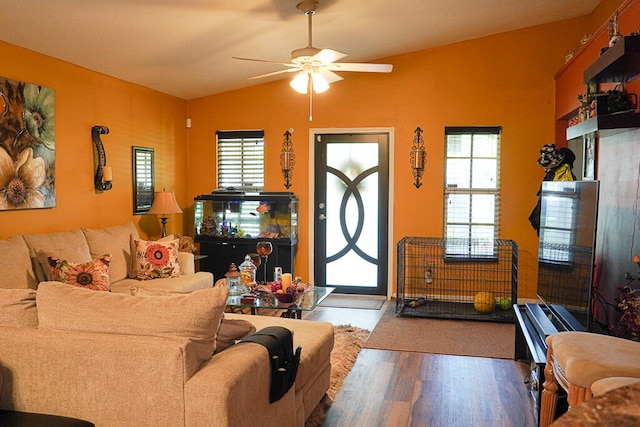 living room featuring hardwood / wood-style floors, ceiling fan, vaulted ceiling, and a healthy amount of sunlight