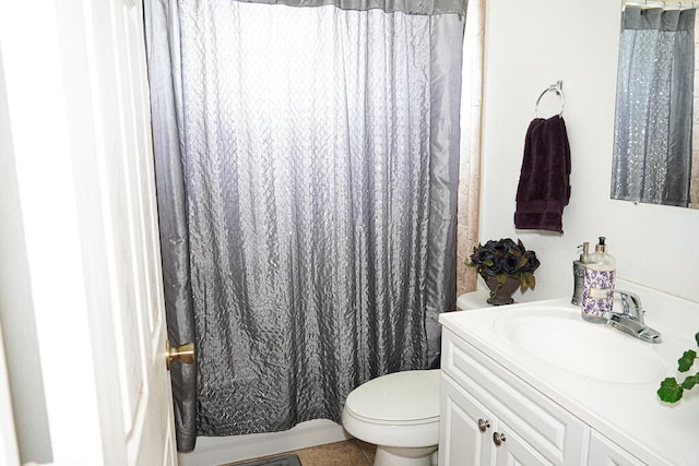 bathroom with a shower with shower curtain, tile patterned floors, vanity, and toilet