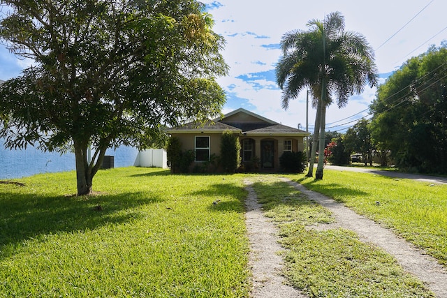 view of front of property with cooling unit and a front lawn