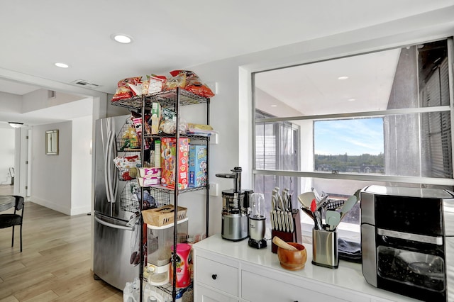 4174 Inverrary Dr Unit 914, Lauderhill, FL 33319 - kitchen with light wood-type flooring, recessed lighting, freestanding refrigerator, and white cabinets