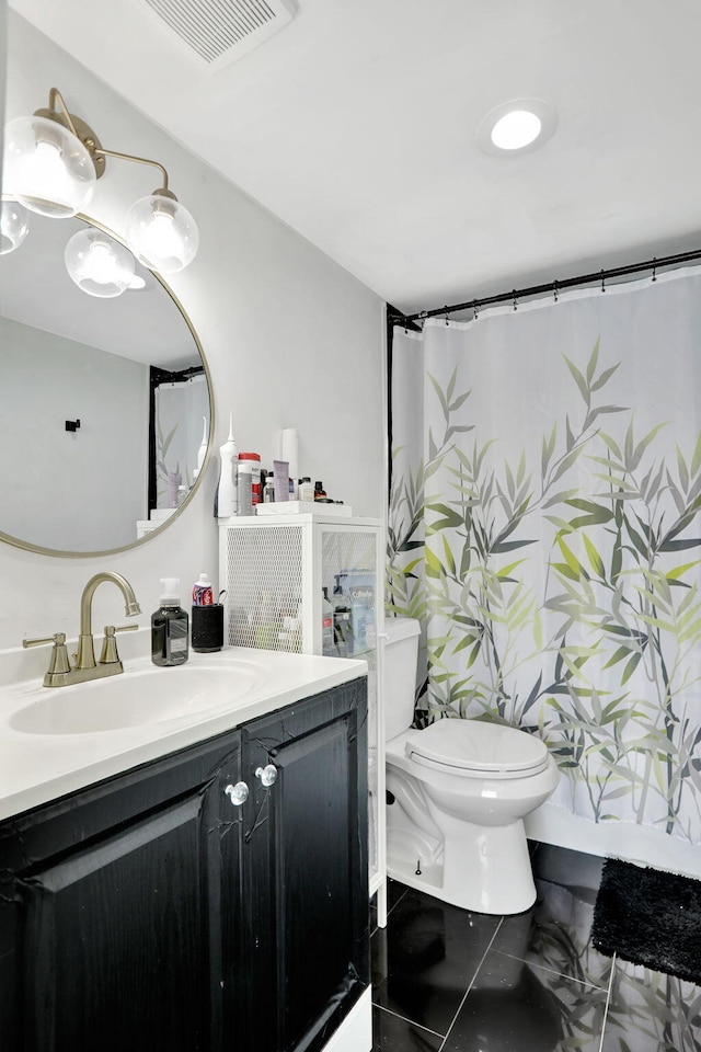 bathroom featuring toilet, vanity, and tile patterned floors