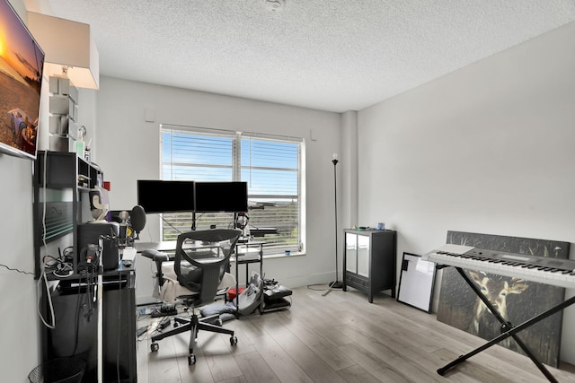 office with a textured ceiling and light hardwood / wood-style flooring