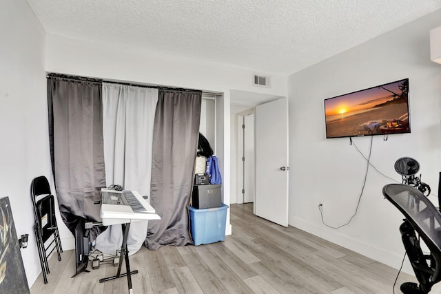 office featuring light hardwood / wood-style flooring and a textured ceiling