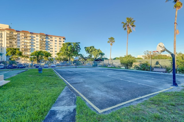 view of sport court with a lawn