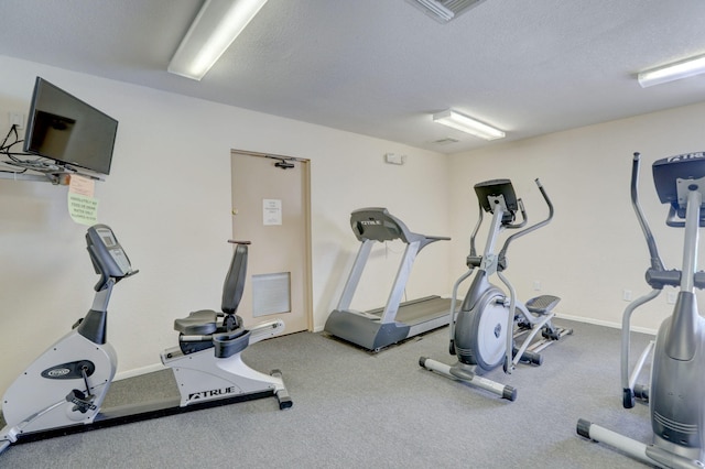 gym featuring a textured ceiling