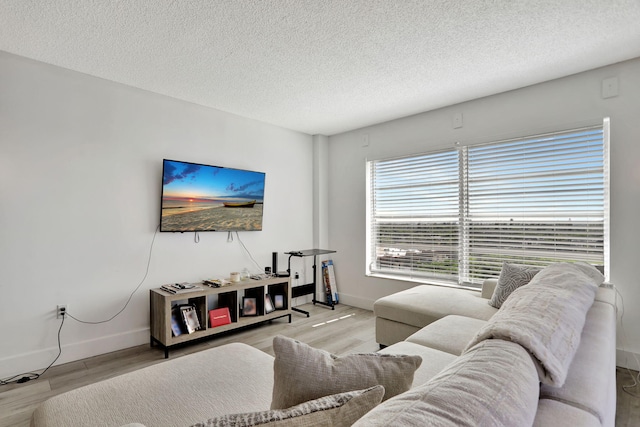 living room featuring a textured ceiling and light hardwood / wood-style floors