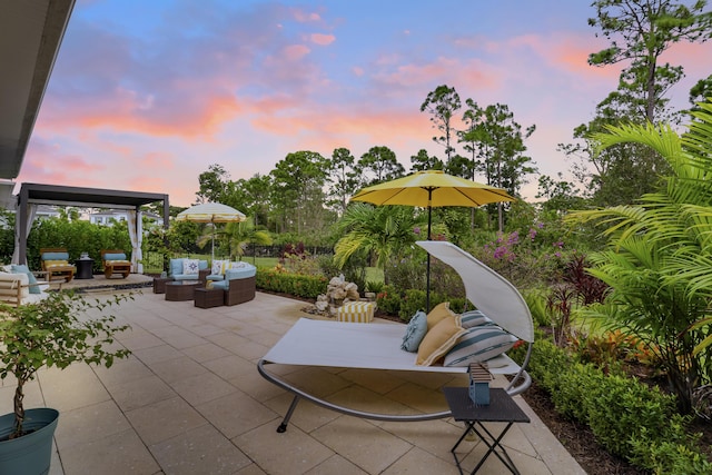 patio terrace at dusk featuring an outdoor living space