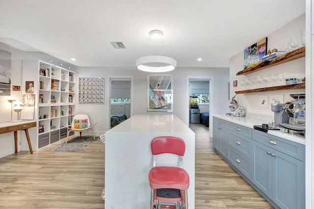 kitchen featuring light wood-type flooring and a breakfast bar area