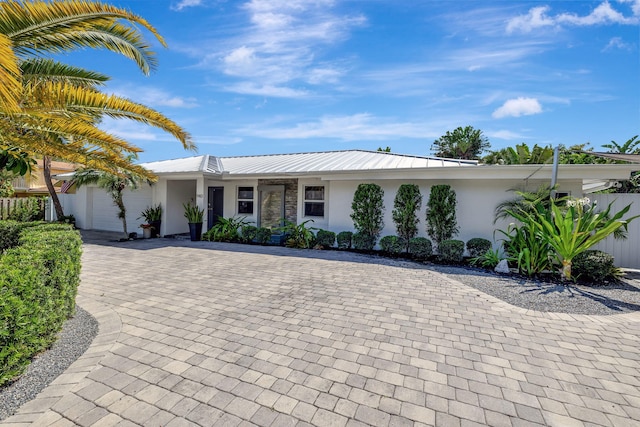 ranch-style home featuring a garage