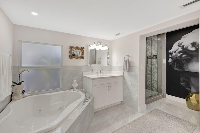 bathroom featuring shower with separate bathtub and vanity