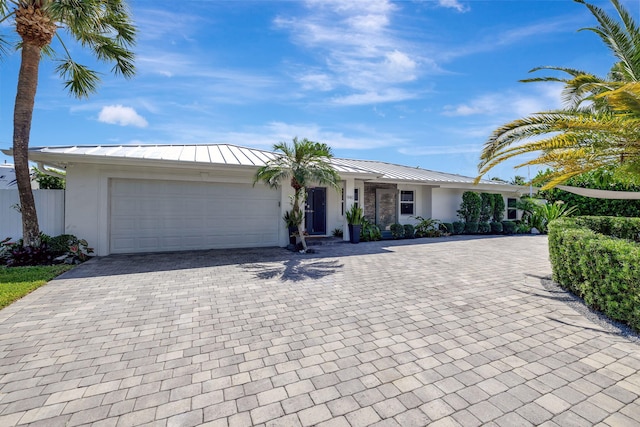 ranch-style home featuring a garage