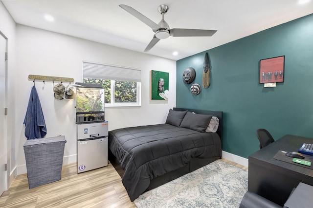 bedroom with ceiling fan and light hardwood / wood-style flooring