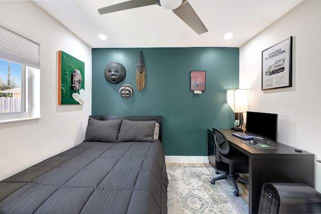 bedroom with ceiling fan and hardwood / wood-style flooring