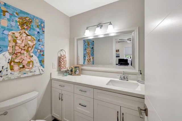 bathroom featuring vanity and toilet