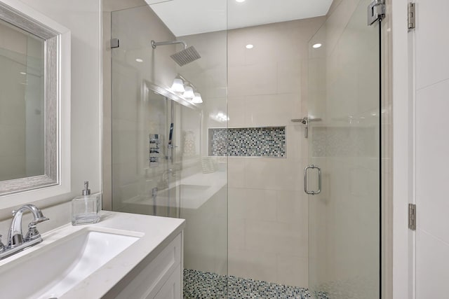 bathroom with vanity and a shower with door