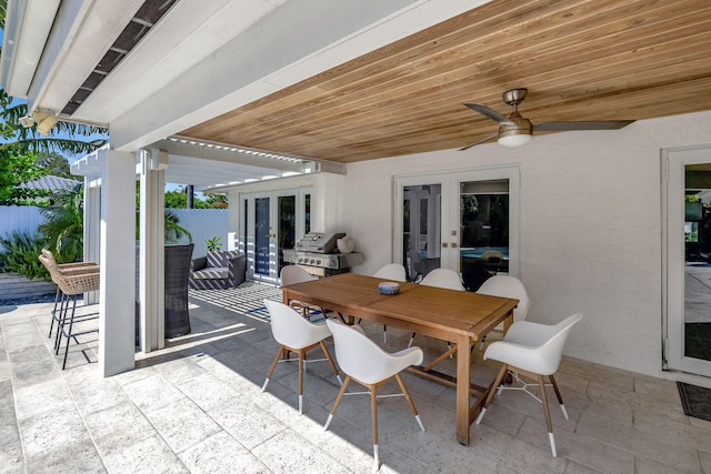 view of patio featuring ceiling fan, a grill, and french doors