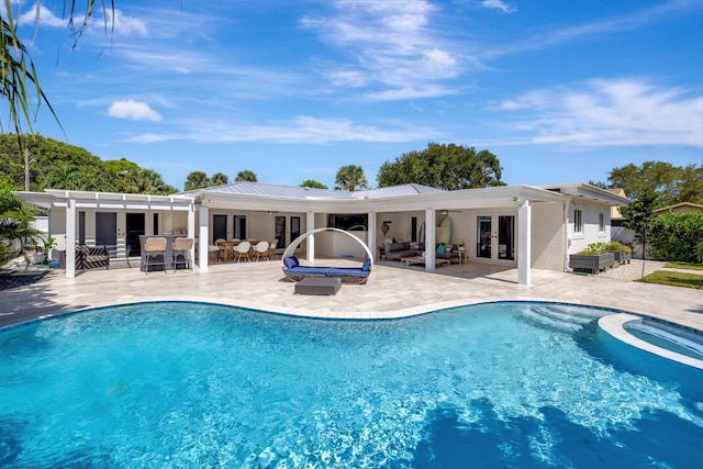 view of pool with french doors, an outdoor hangout area, an in ground hot tub, and a patio