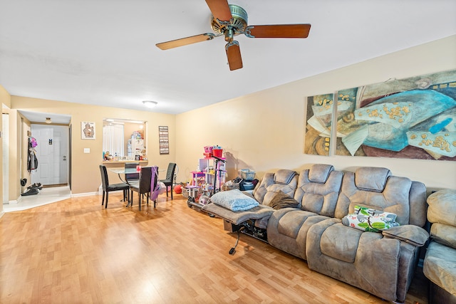 living room featuring ceiling fan and light hardwood / wood-style floors