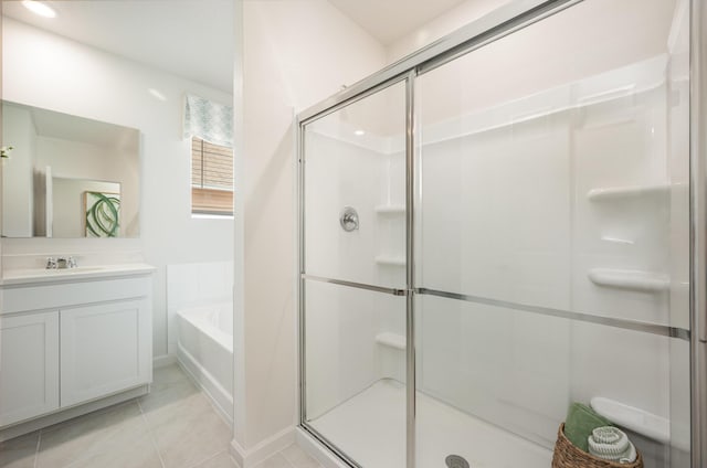 full bath with tile patterned floors, a shower stall, vanity, and a garden tub