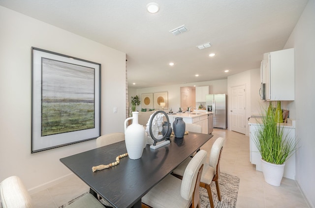 dining space with light tile patterned floors, recessed lighting, and visible vents