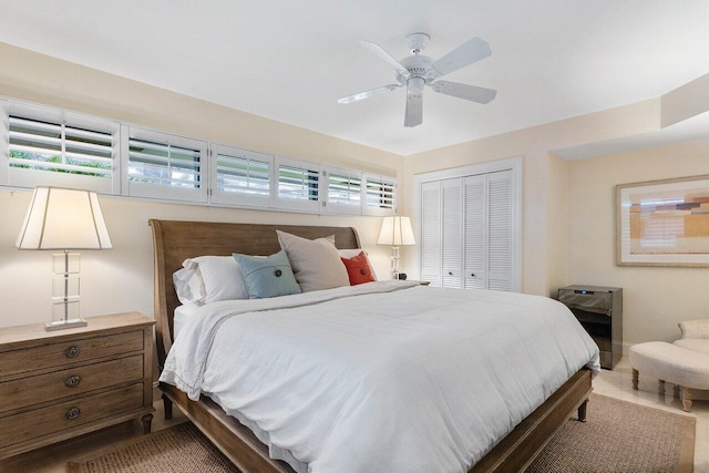 bedroom featuring multiple windows, a closet, and ceiling fan