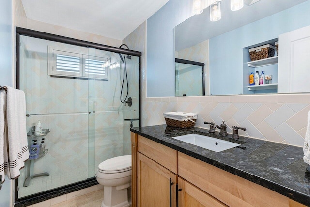 bathroom featuring tile patterned flooring, an enclosed shower, toilet, vanity, and tile walls