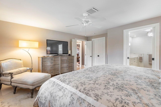 bedroom with carpet flooring, ensuite bathroom, and ceiling fan