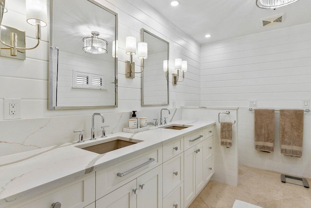 bathroom featuring tile patterned flooring, vanity, and tile walls