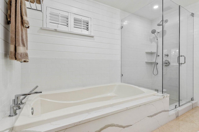 bathroom with tile patterned floors and independent shower and bath