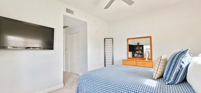 carpeted bedroom featuring ceiling fan and a closet