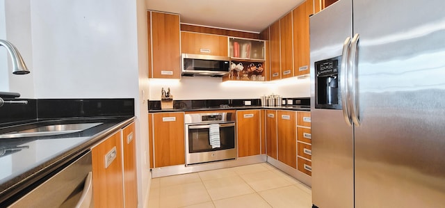 kitchen with light tile patterned floors, sink, and stainless steel appliances