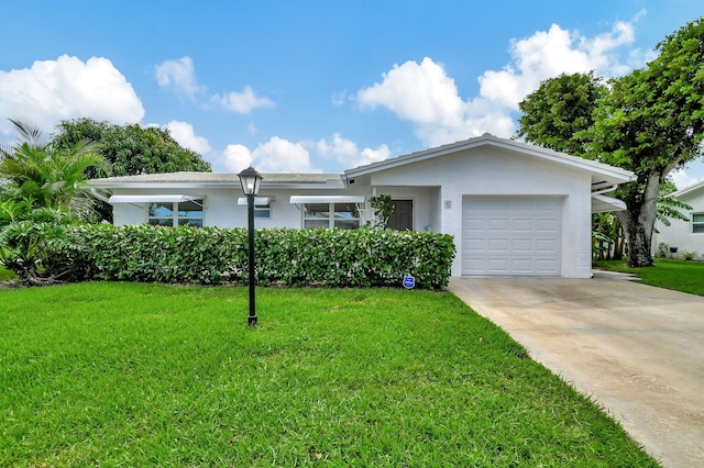 ranch-style house with a garage and a front lawn