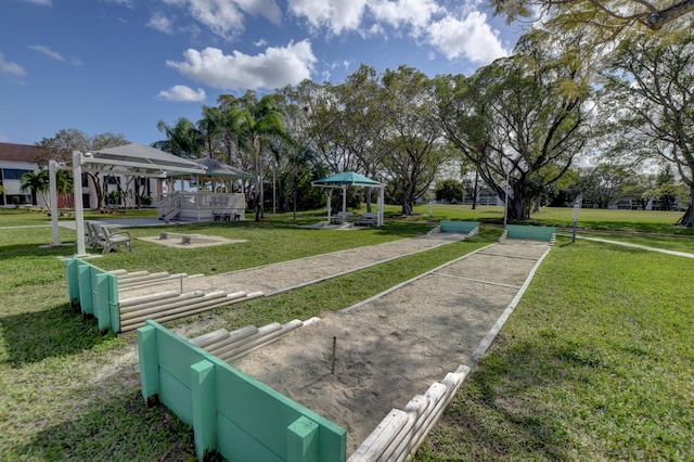 surrounding community with a gazebo and a yard