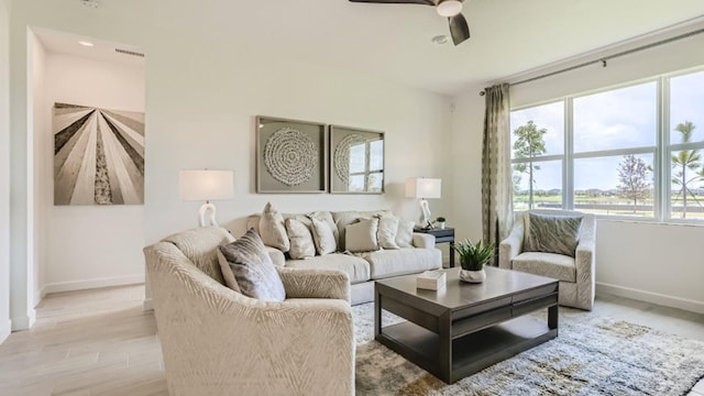 living room featuring ceiling fan and light hardwood / wood-style flooring