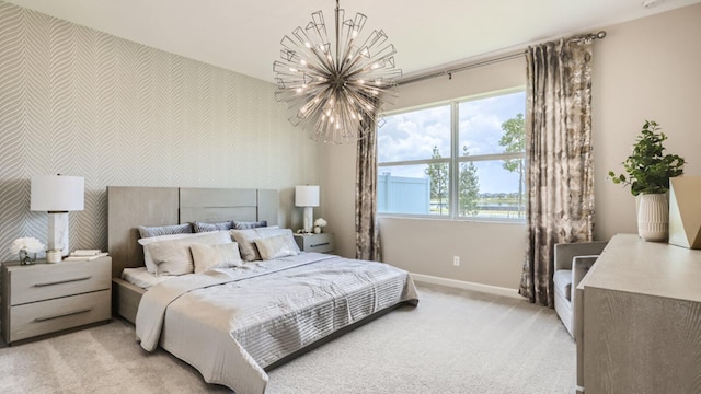 bedroom featuring an inviting chandelier and light colored carpet