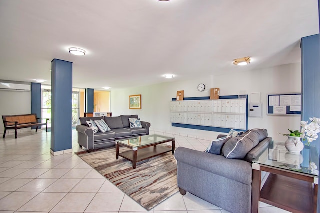 tiled living room featuring mail boxes and a wall unit AC