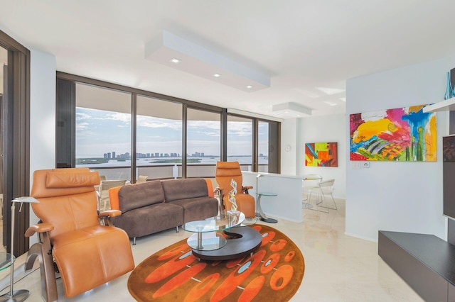 living room with a wall of windows and light tile patterned floors