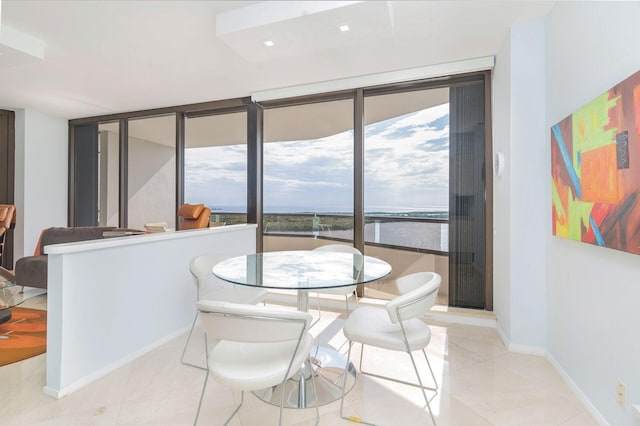 tiled dining space with expansive windows