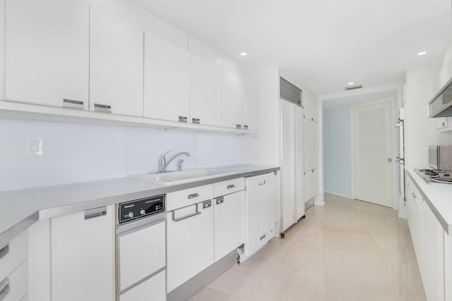 kitchen featuring sink, light tile patterned flooring, stainless steel gas cooktop, white cabinetry, and white dishwasher