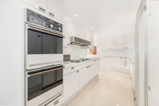 kitchen featuring exhaust hood, white gas stovetop, white cabinets, and double wall oven