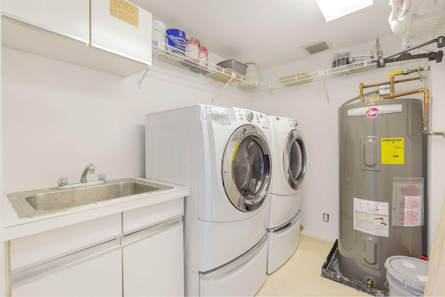 washroom with sink, electric water heater, and washer and clothes dryer