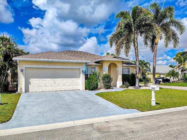 view of front of home featuring a front lawn and a garage